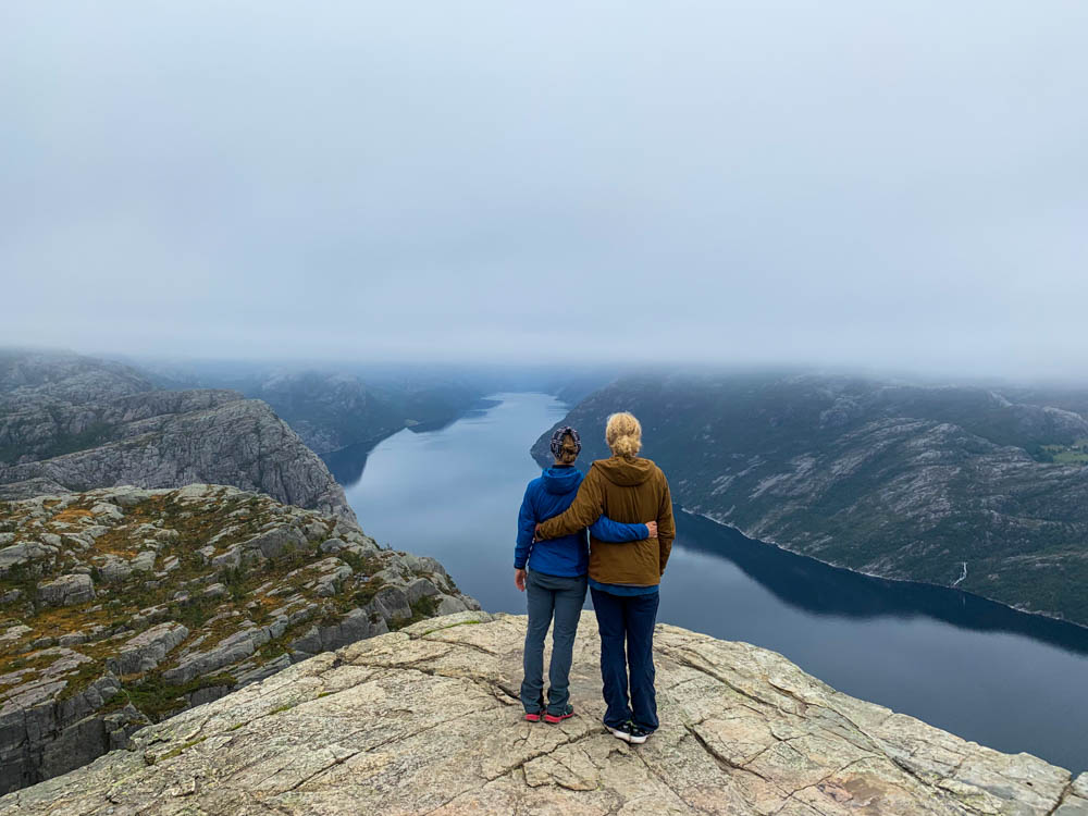 Norwegen, Melanie und Julian stehen auf dem Preikestolen in Norwegen und schauen in die Ferne.
