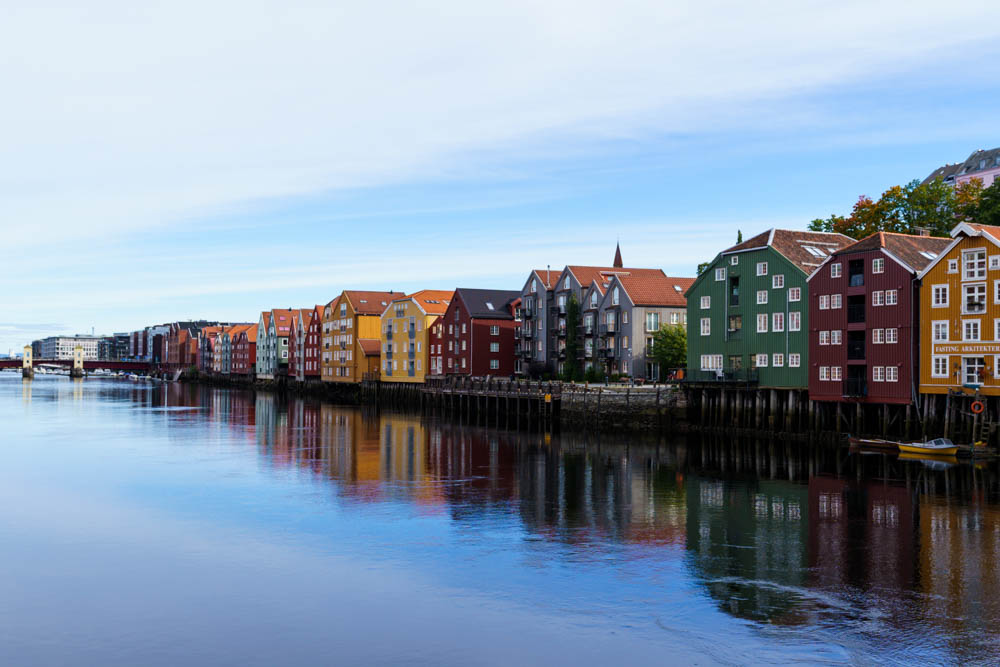 Bunte Häuser auf Stelzen am Fluss in Trondheim.