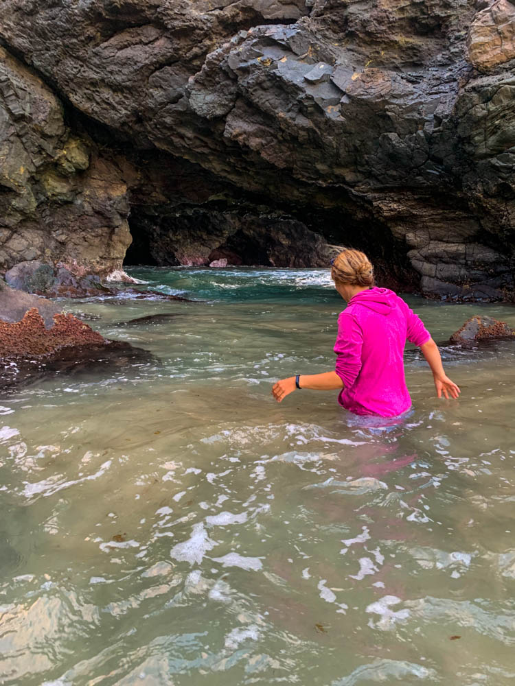 Melanie ist bis zur Hüfte im Atlantik versunken und erkundet eine Höhle bei Los Molinos. Fuerteventura entdecken - Höhlenforscher